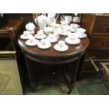 A late Victorian mahogany two tier occasional table having pierced fretwork and turned column