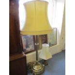 A mid 20th century brass standard lamp with shade, together with a brass table lamp and shade