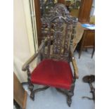 A late Victorian oak carved Carolean style armchair