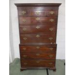 A George III mahogany chest on chest having a moulded and blind fret carved cornice, over three