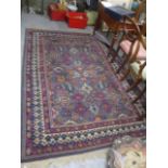 A Turkish rug with geometric motifs, on a grey and blue ground