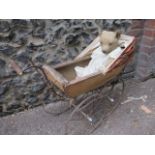 A Victorian child's pram, together with an early 20th century teddy bear