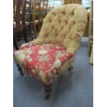 A Victorian nursing chair with mahogany legs