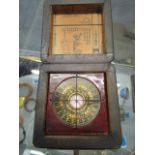 A contemporary Chinese brass and lacquered compass and gilded wooden box, lid set with a brass coin