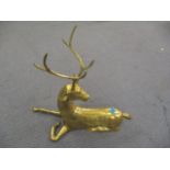 A brass model of a stag laying down
