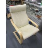 An as new Ikea, cream leather upholstered and laminated, framed armchair