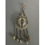 A Chinese white metal bottle decorated with twin fish motifs and pierced work, suspended on a