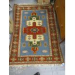 A Turkish rug with geometric motifs on a blue ground,