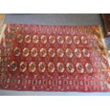 An Indian red ground rug with elephant gull motifs, 67" x 40"