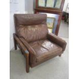 A mid 20th century brown leather upholstered armchair