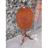 A Victorian mahogany, oval tilt topped table with bobbin turned support