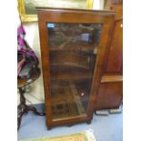 A 20th century rosewood display cabinet with four shelves and a single glazed door, 50" x 22" x 11"