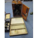 A Beck microscope in a wooden case, a smaller students microscope and mixed slides