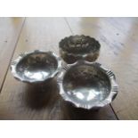 Three Indian white metal dishes, to include two footed dishes