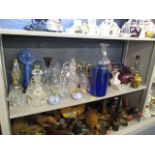 A large mixed lot of glassware to include decanters, vases, drinking glasses and other items