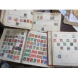 Three stamp albums containing stamps from around the world