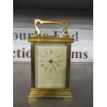 An early 20th century brass cased carriage clock, the dial inscribed Taylor & Bligh, London Gh