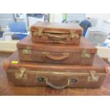 Three leather cases of various sizes