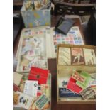 A stamp album, loose stamps, match box wrappers, cigarette and beer wrappers and a geometry set