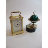 Taylor & Bligh, London - a brass cased carriage clock and a musical lighter in the form of a globe