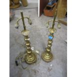 A pair of brass table lamps on wooden stands with two bulb fittings