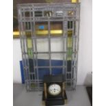 An early 20th century stained glass window and a slate and marble cased mantle clock