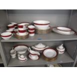 A Spode Bordeaux pattern dinner service decorated with a mottled red band and gilt ornament