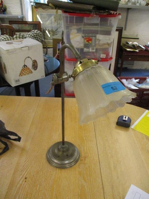 A gilt adjustable table lamp with an opaque shade