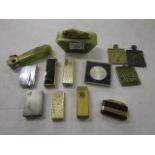 A mixed lot of lighters to include a Dunhill silver plated lighter, three brass reliquary plaques