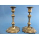 A pair of late Victorian silver candlesticks by James Hutton & Sons, London 1900, with a square,