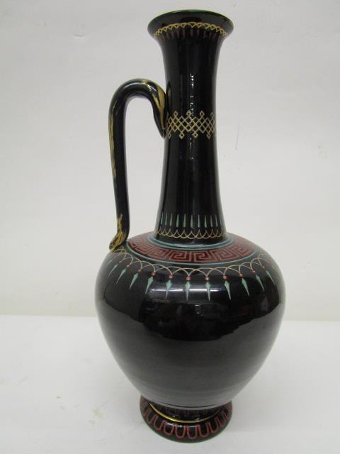 A late 19th century Harrach black glass bottle vase with single handle and enamelled decoration of a