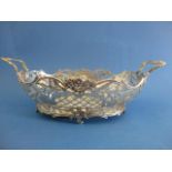 A late 19th century French silver basket with twin, floral handles, pierced, engraved sides with