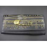 A Versus Versace clutch bag with iconic safety pin and stud design in black