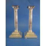 A pair of Victorian silver candlesticks by Hawksworth Eyre & Co Ltd, Sheffield 1898, with a