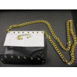 A Versus Versace two tone clutch bag in black and white with iconic gold coloured safety pin to