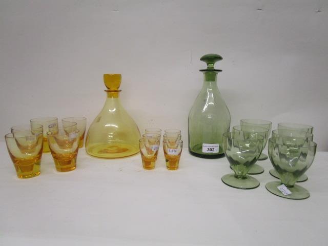 Barnaby Powell designs for Whitefriars glass, two decanter and glass sets, the first in pattern M60,