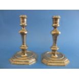 A pair of cast silver candlesticks by Soloman Joel, Philips, London 1968 with a knopped stem on a