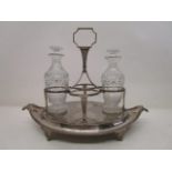 A George III silver cruet stand by Henry Nutting, London 1807 with a central handle, four bottle and