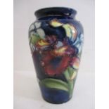 A Moorcroft pottery Orchid and Wildflower pattern vase on a blue ground with impressed marks, 5" h