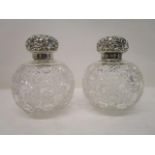 A pair of late Victorian silver and clear glass decanters by James Deakin & Son, Chester 1899 with a