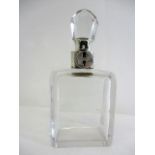 A Christopher Dresser design clear glass decanter with a silver lockable collar by Hukin & Heath,