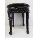 A late 19th century Chinese hardwood stand with a mottled brown, marble top, a moulded, carved and