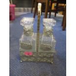 A silver plated double decanter Tantalus with labels