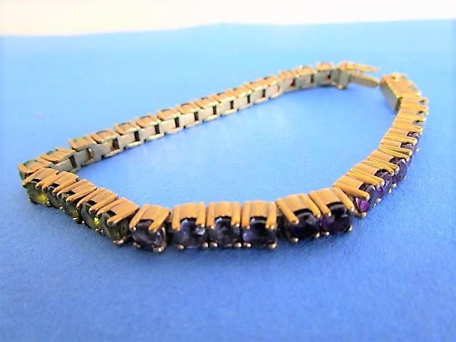 A 9ct gold articulated bracelet set with thirty eight coloured stones, 18.7g, total
