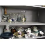 A mixed lot of ceramics to include mixed tea cups and saucers, a cake stand, an oil lamp, mixed