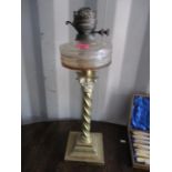 A Victorian oil lamp having a brass Corinthian column and a stepped base