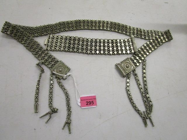 A 19th century white metal belt with six pendant chains and a matching bracelet