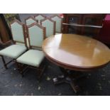 A modern mahogany circular extending table 31"h x 45"w and six beech dining chairs