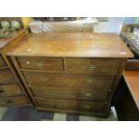 An early 20th century mahogany flat fronted chest of two short and three long drawers on bracket