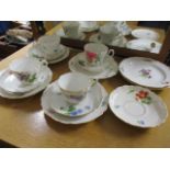 An early 20th century Meissen part tea set decorated with sprigs of flowers comprising four teacups,